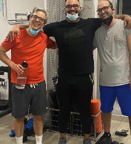 Fernando Quintero coaching two APX Fitness clients in the gym