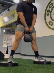Loaded carry with a kettlebell during an APX Fitness training session
