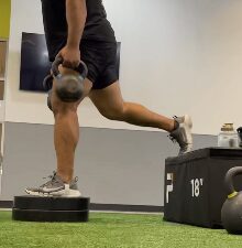 Single-leg step-up with kettlebells at APX Fitness